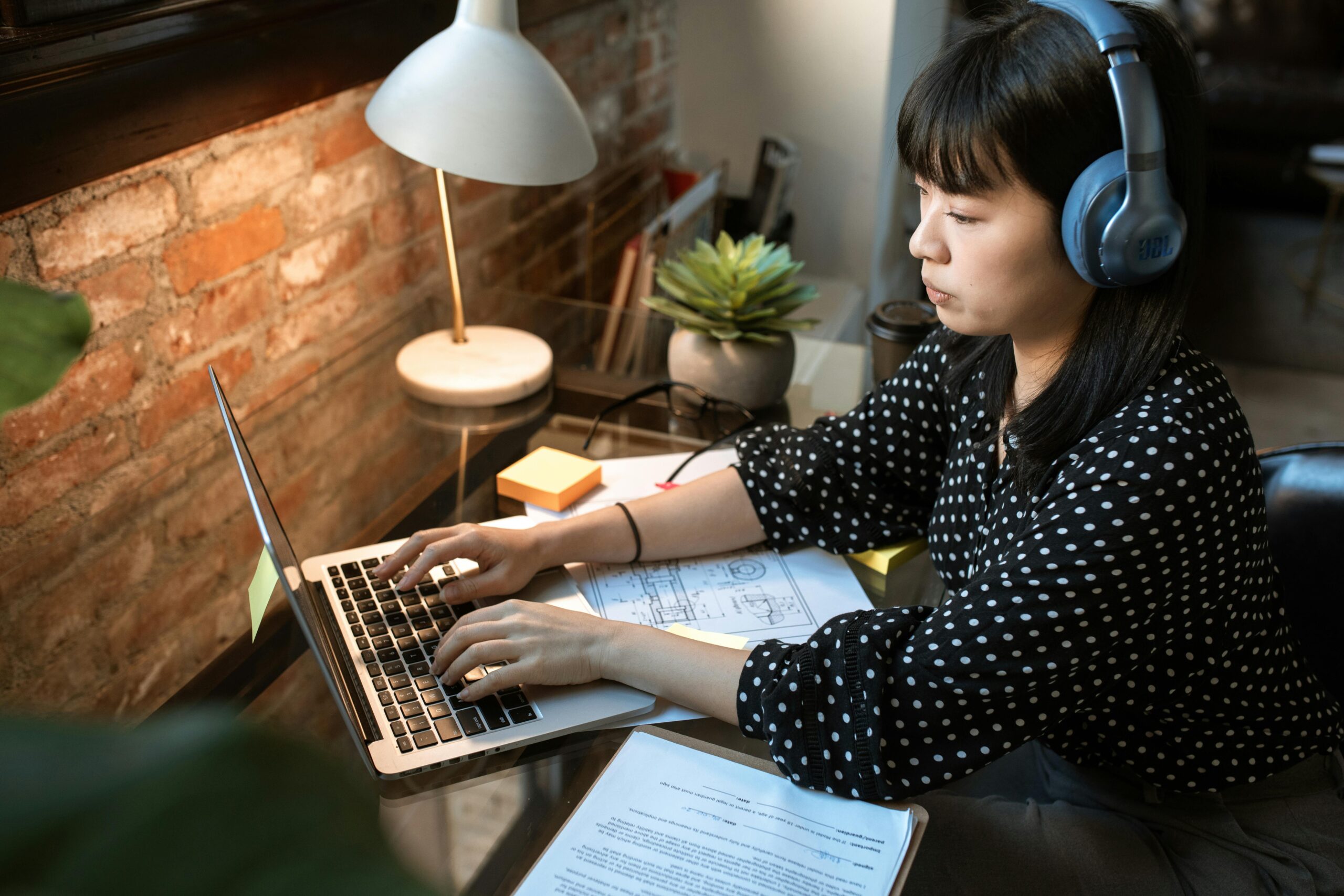 female with laptop with lamp on the side working